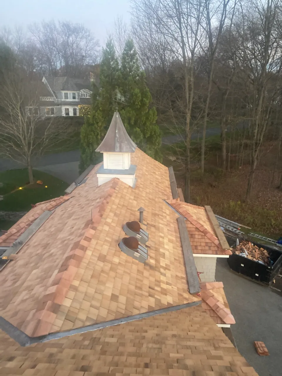 Cedar shake roof detail around cupola in Darien CT